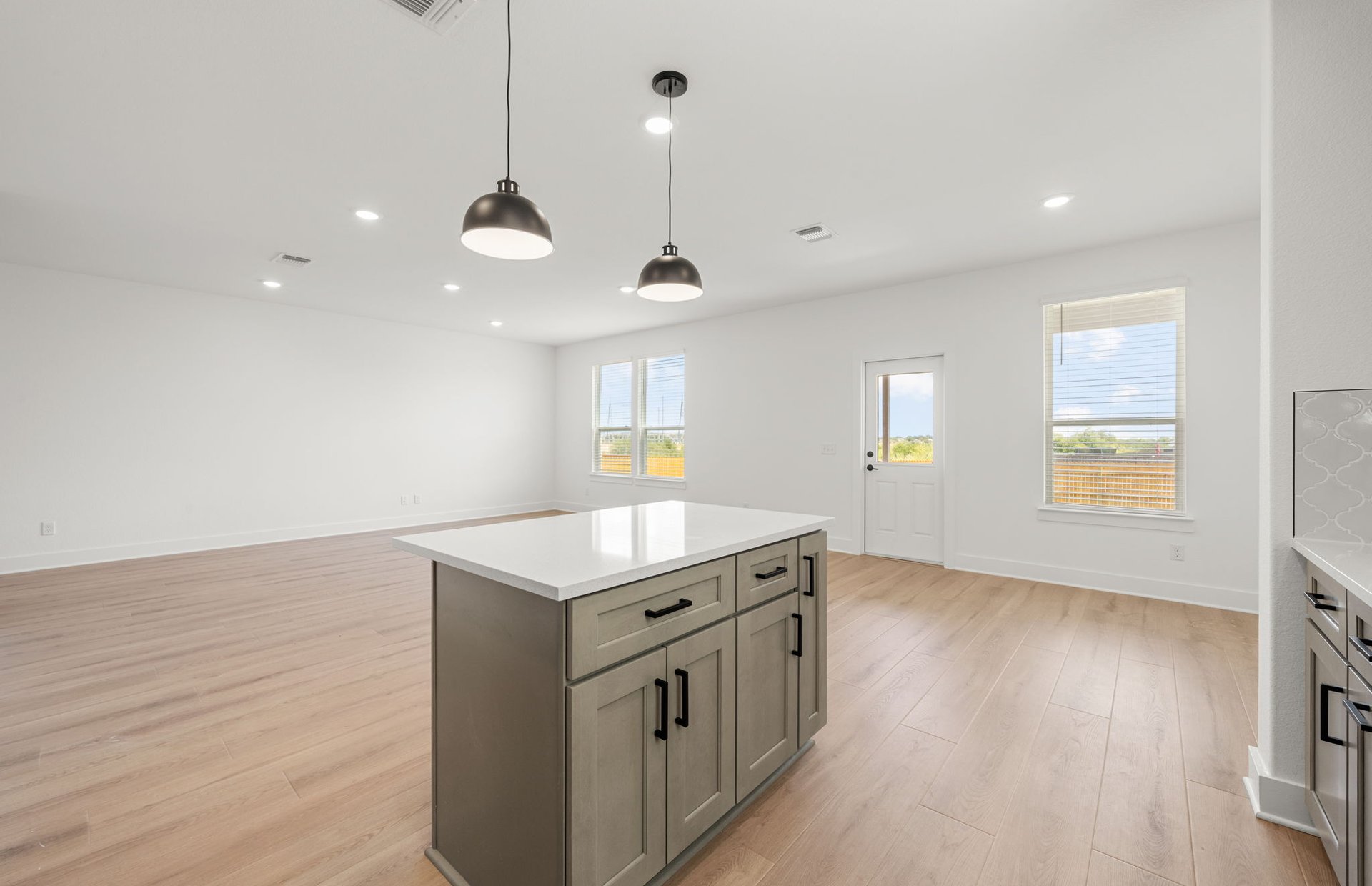 560 Tailwind Drive Kyle, TX 78640 - Photo 9 of 37 a kitchen with a sink and chandelier