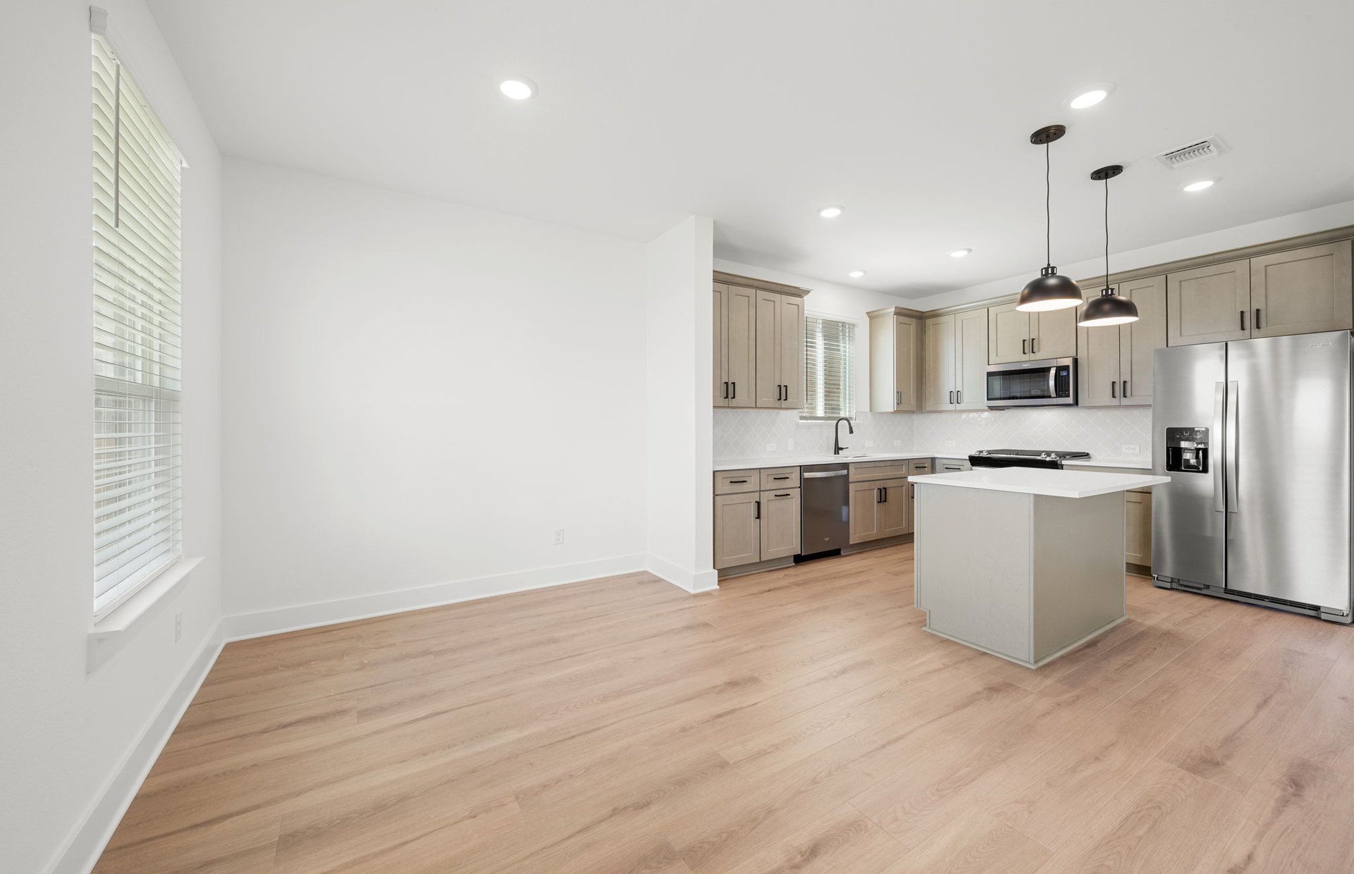 560 Tailwind Drive Kyle, TX 78640 - Photo 13 of 37 a view of kitchen with stainless steel appliances granite countertop a stove top oven a sink and a refrigerator