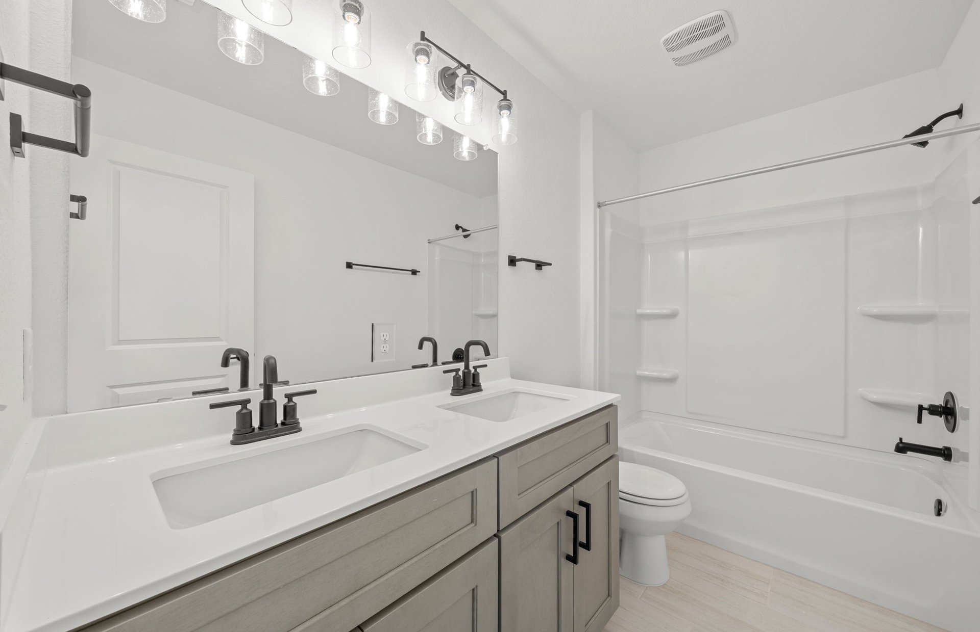 560 Tailwind Drive Kyle, TX 78640 - Photo 24 of 37 a bathroom with a sink a toilet a shower and a mirror