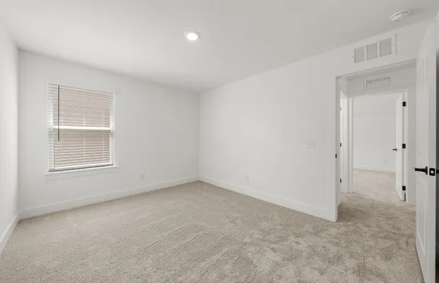 a view of an empty room with a ceiling fan