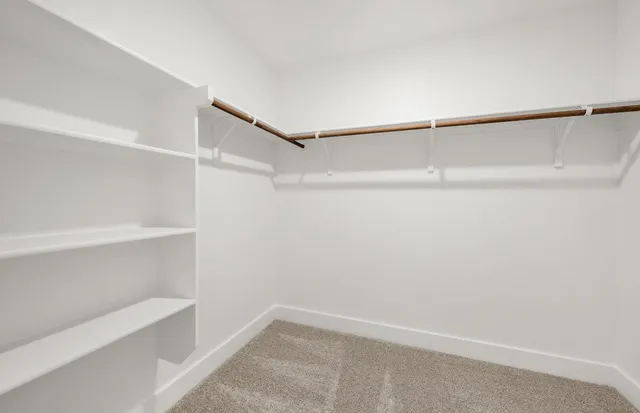 a bathroom with a sink a toilet a mirror and shower