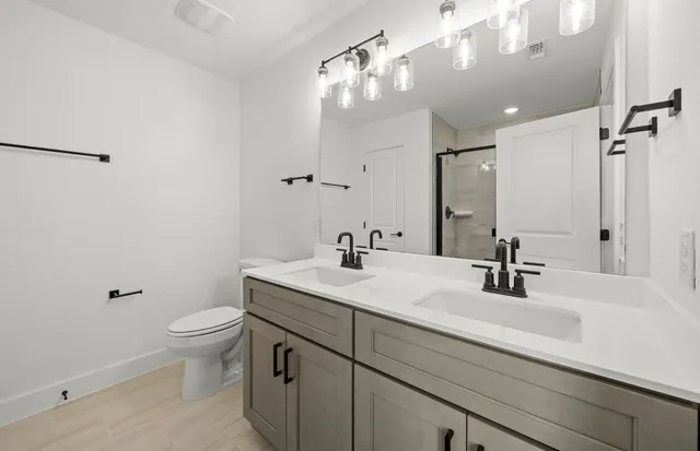 a bathroom with a sink a vanity a mirror and shower