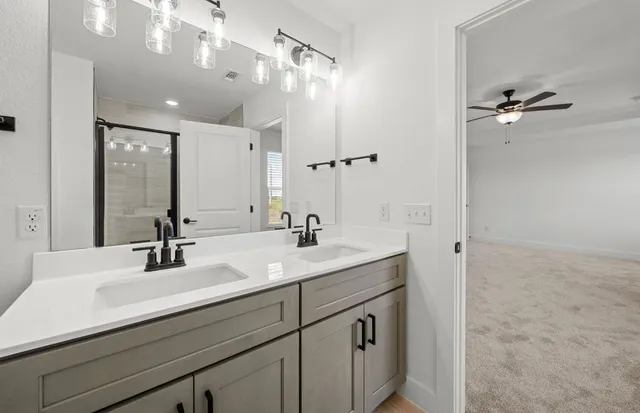 a bathroom with a glass shower door