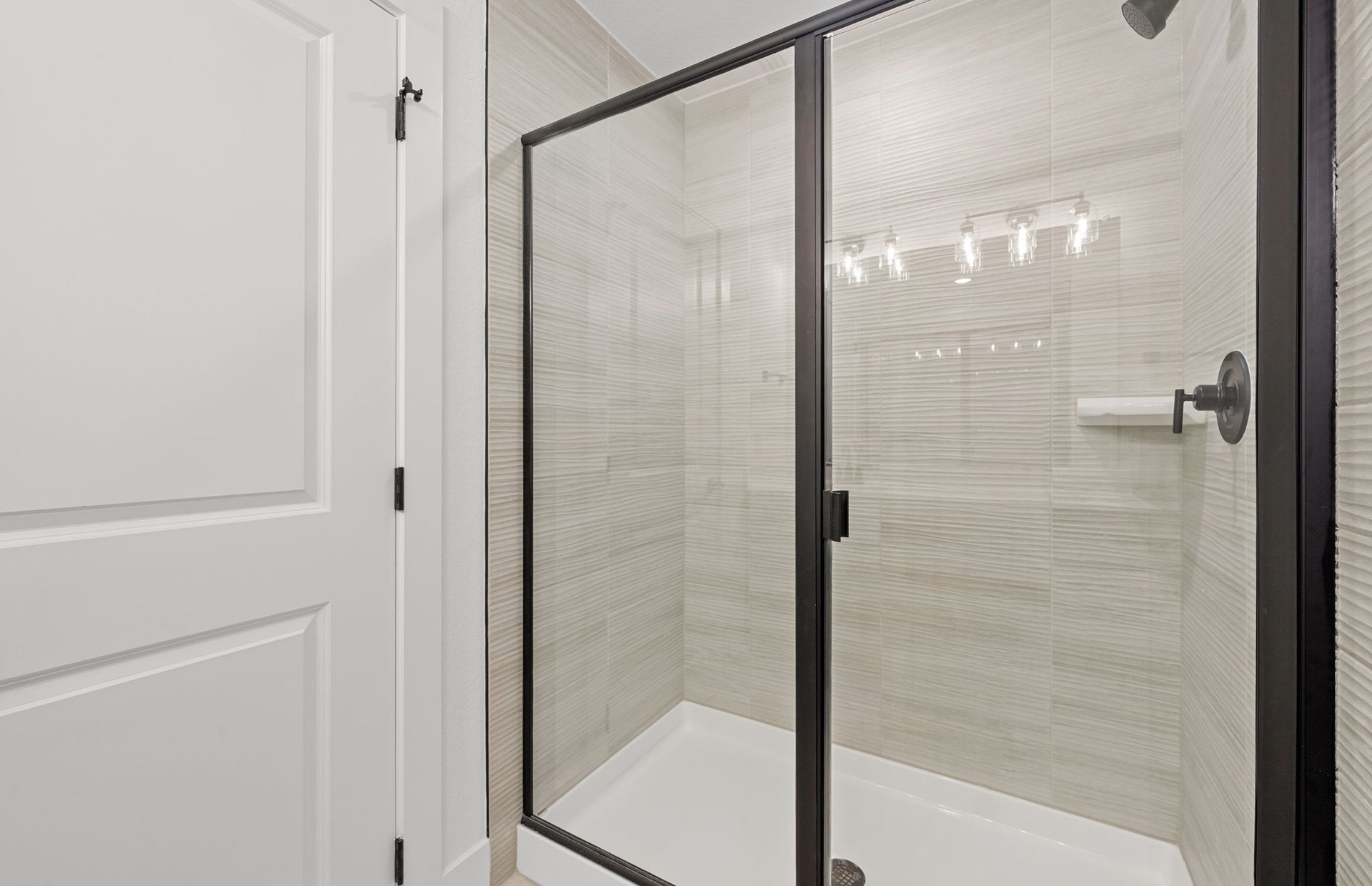 560 Tailwind Drive Kyle, TX 78640 - Photo 32 of 37 a bathroom with a glass shower door