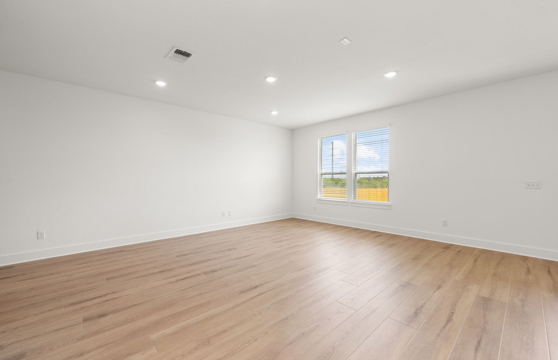 560 Tailwind Drive Kyle, TX 78640 - Photo 5 of 37 a view of an empty room with wooden floor and a window