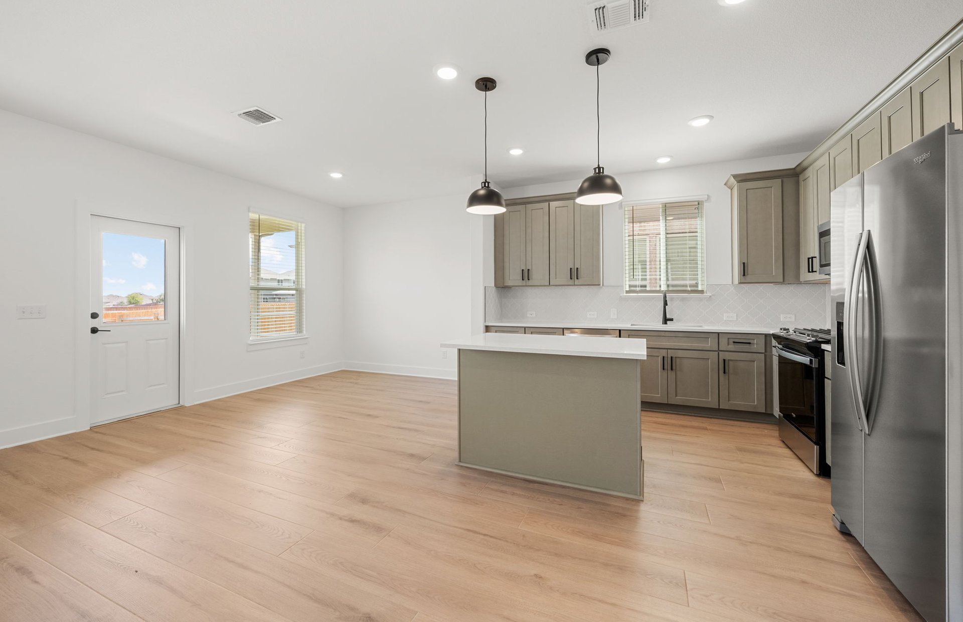 560 Tailwind Drive Kyle, TX 78640 - Photo 6 of 37 a kitchen with kitchen island a sink stainless steel appliances and window