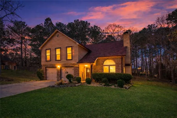 a front view of a house with garden
