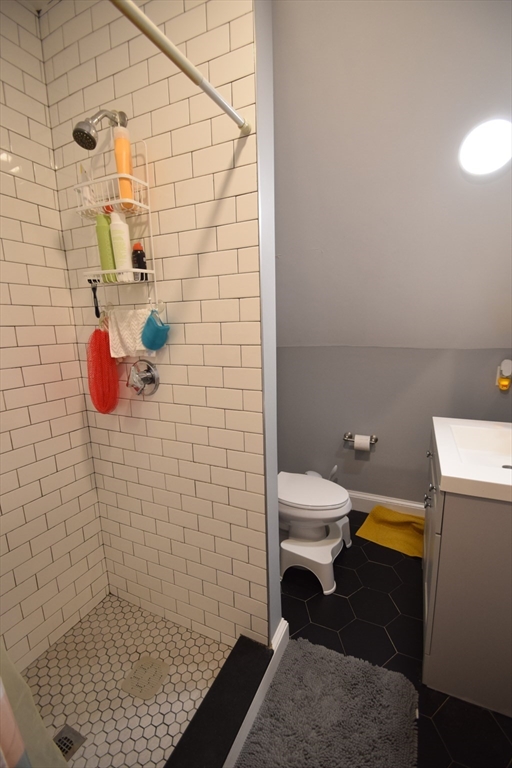 33-35 Ridgemont Street, Unit 3 Boston, MA 02134 - Photo 6 of 12 a bathroom with a toilet and a shower