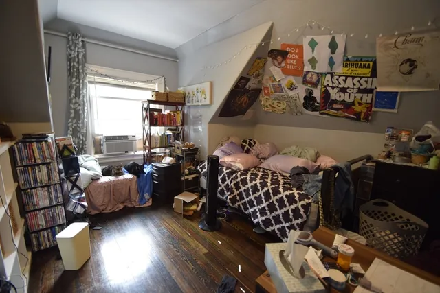 a bedroom with furniture and a large window