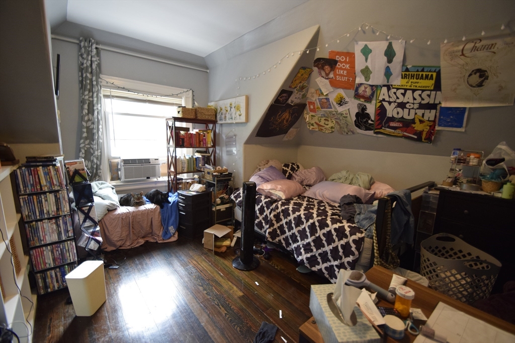 33-35 Ridgemont Street, Unit 3 Boston, MA 02134 - Photo 7 of 12 a bedroom with furniture and a large window