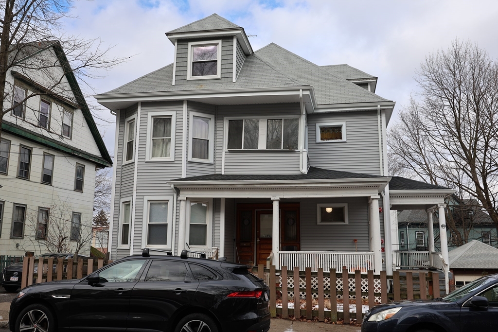 33-35 Ridgemont Street, Unit 3 Boston, MA 02134 - Photo 10 of 12 a front view of a house with lots of cars parked on road