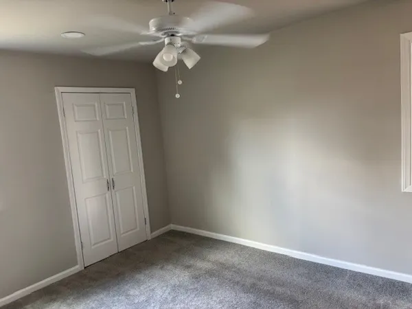 an empty room with a ceiling fan