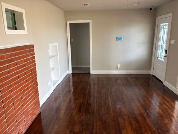 wooden floor in an empty room with a window
