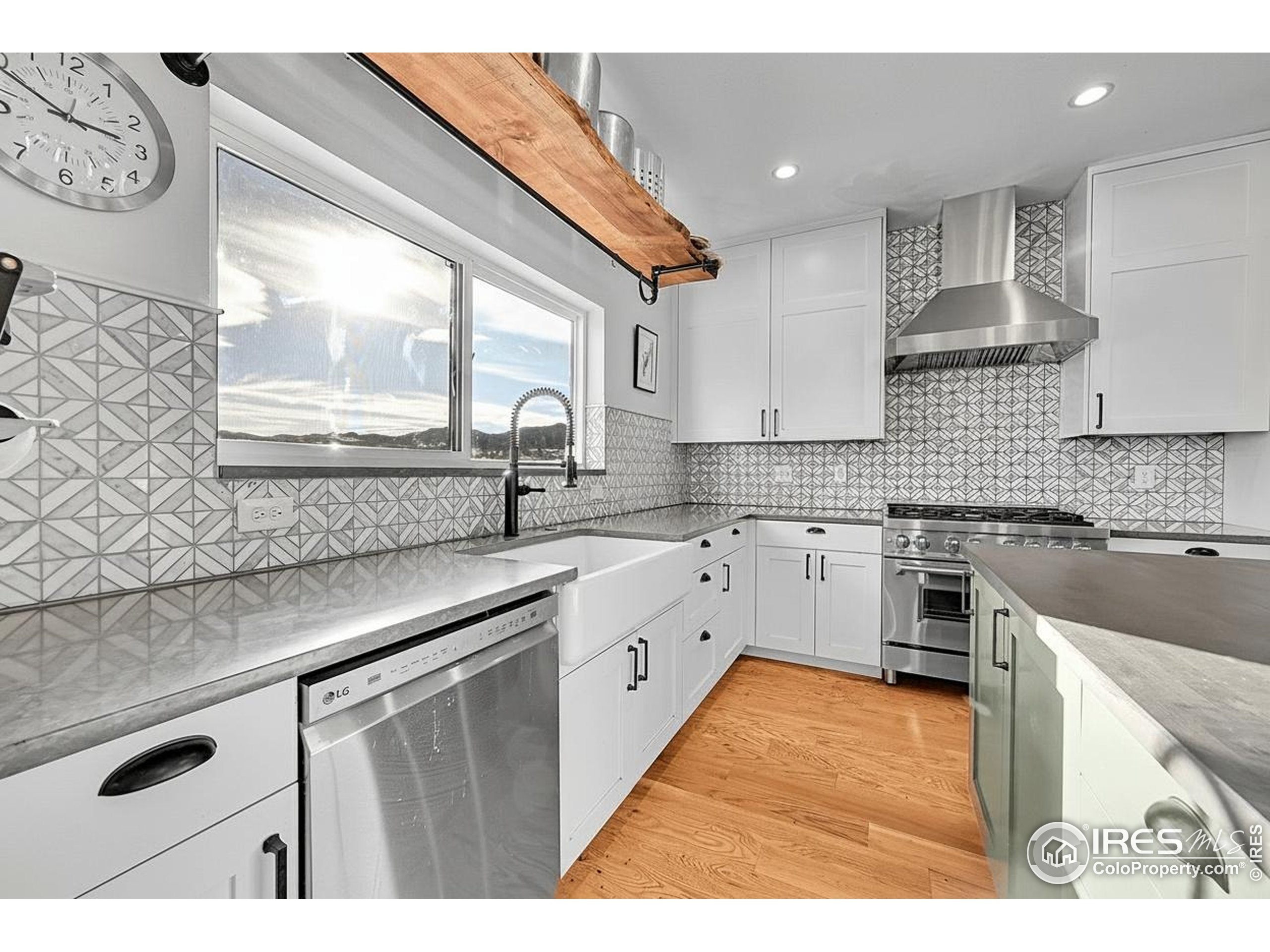 702 Ponderosa Hill Road Lyons, CO 80540 - Photo 11 of 39 a kitchen with cabinets appliances a sink and a window