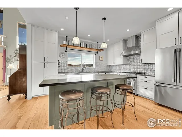 a view of a balcony with wooden floor and fence