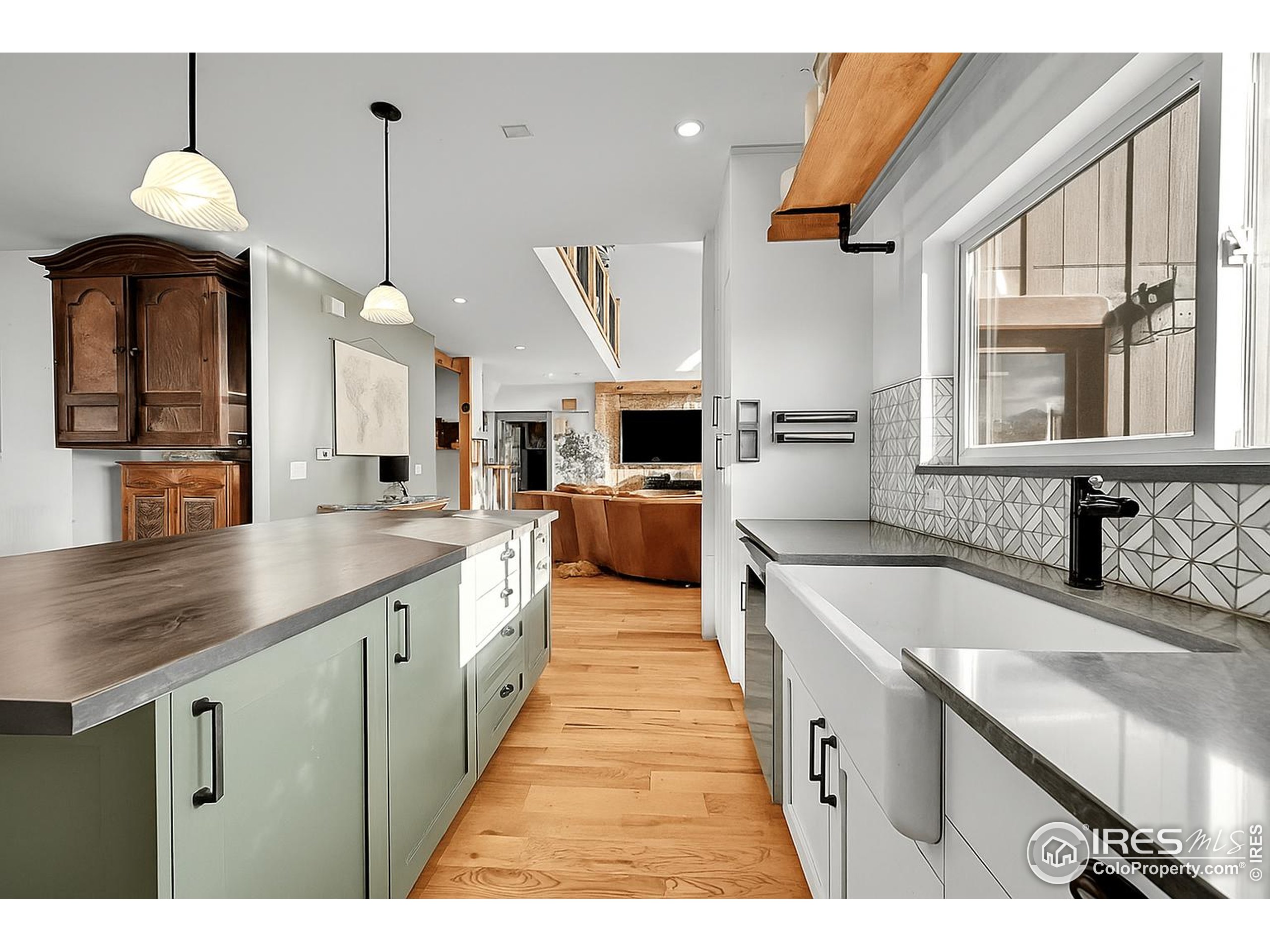 702 Ponderosa Hill Road Lyons, CO 80540 - Photo 13 of 39 a large kitchen with stainless steel appliances kitchen island granite countertop a sink and a wooden floor