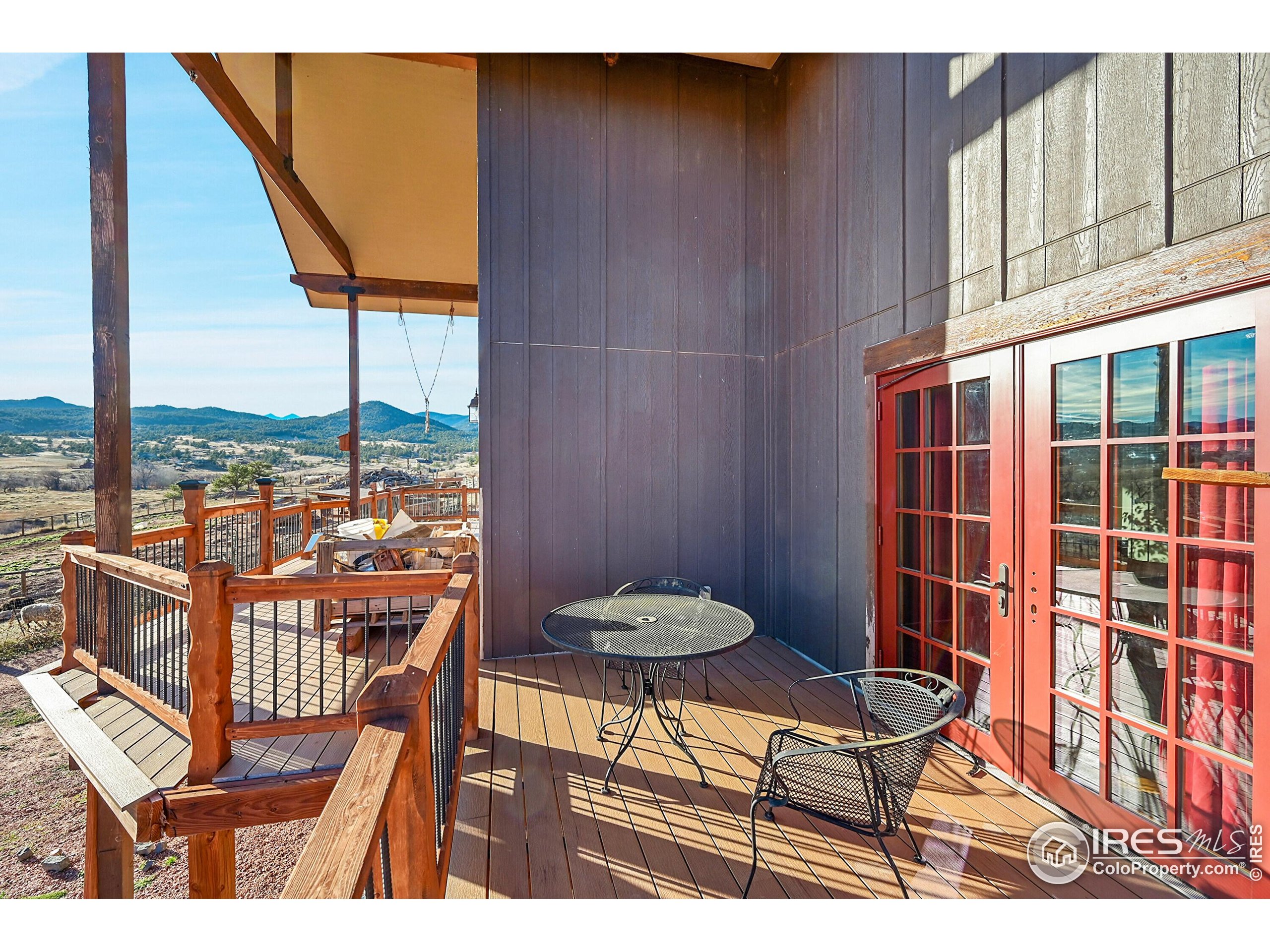 702 Ponderosa Hill Road Lyons, CO 80540 - Photo 18 of 39 a balcony with table and chairs
