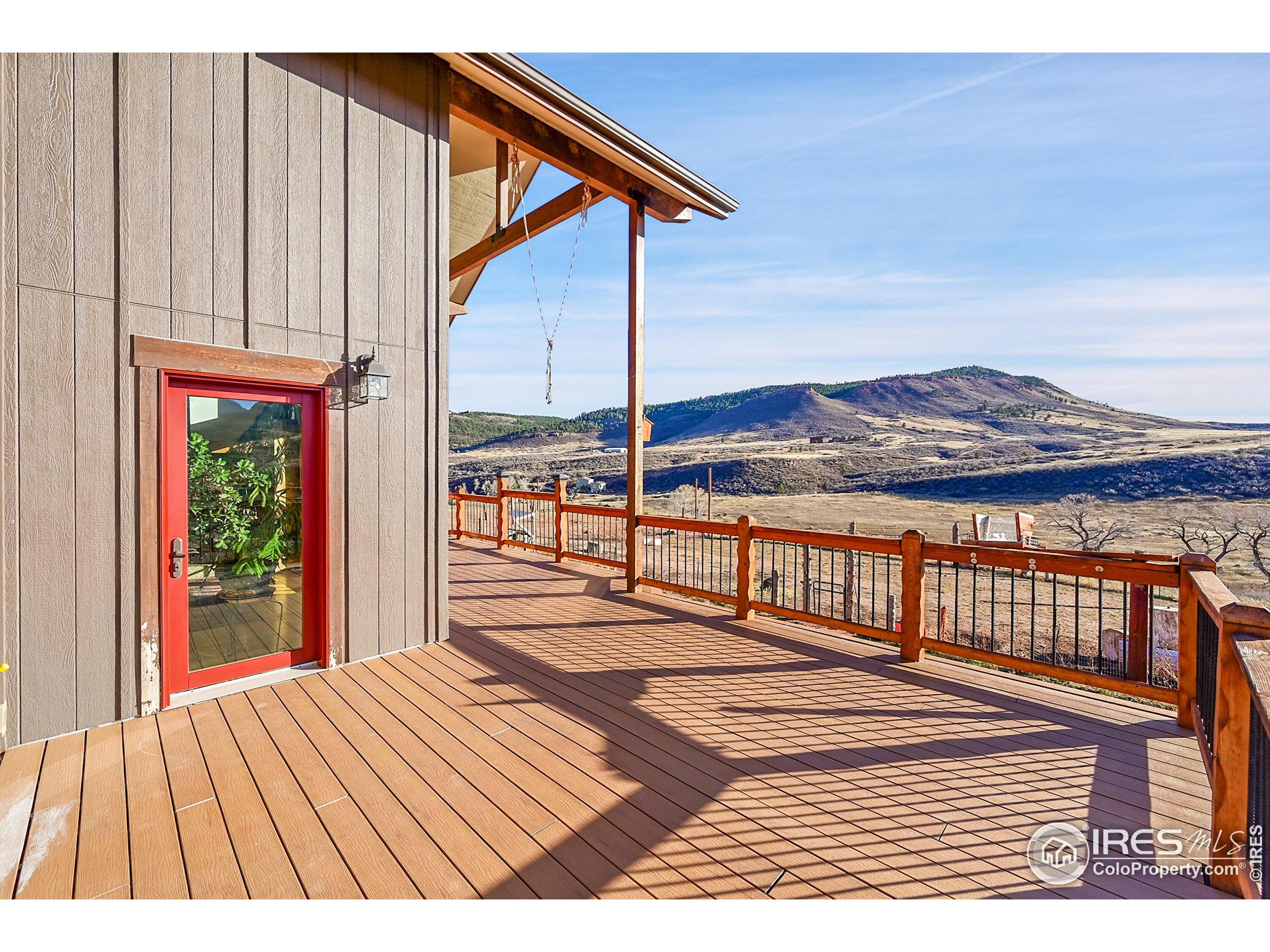 702 Ponderosa Hill Road Lyons, CO 80540 - Photo 19 of 39 a view of a balcony with wooden floor and fence
