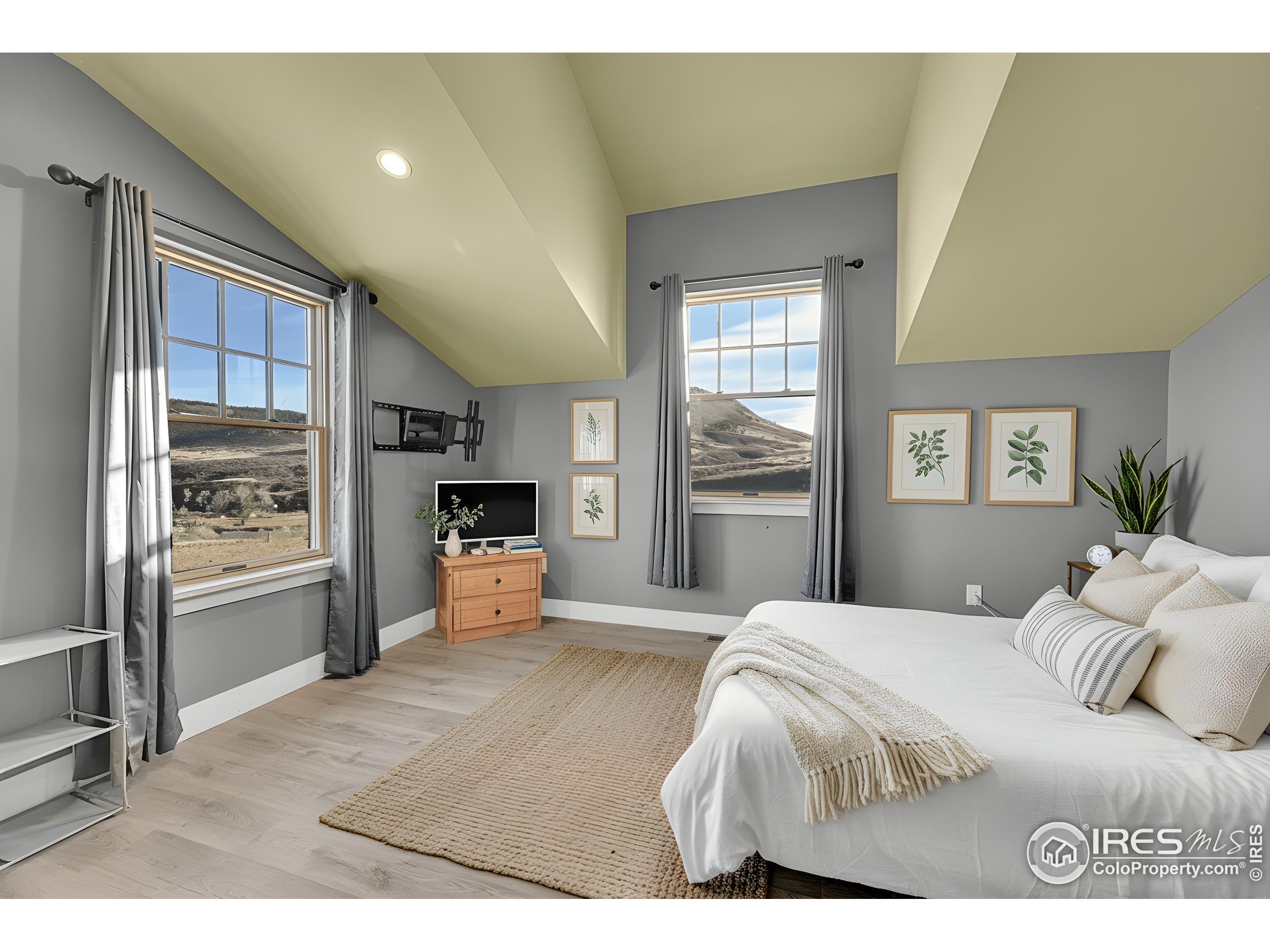 702 Ponderosa Hill Road Lyons, CO 80540 - Photo 22 of 39 a bedroom with a large bed and a window