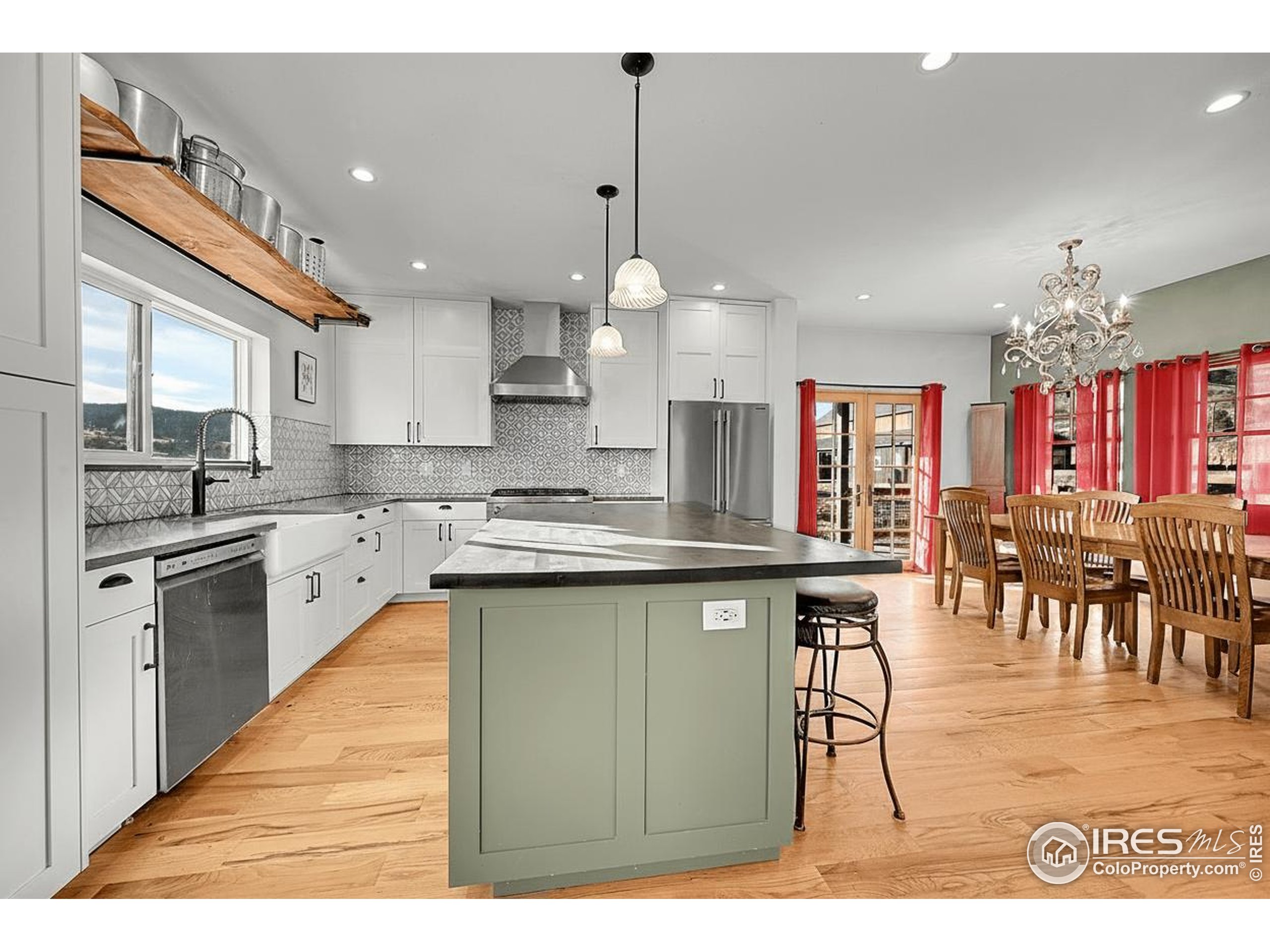 702 Ponderosa Hill Road Lyons, CO 80540 - Photo 10 of 39 a open kitchen with stainless steel appliances granite countertop a stove top oven a sink a dining table and chairs