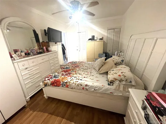 a living room with a flat screen tv and a wooden floor