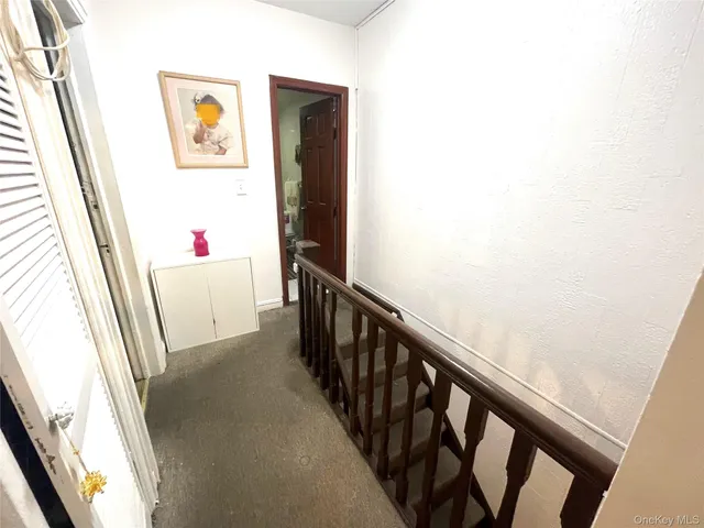 a view of a hallway with furniture and entryway