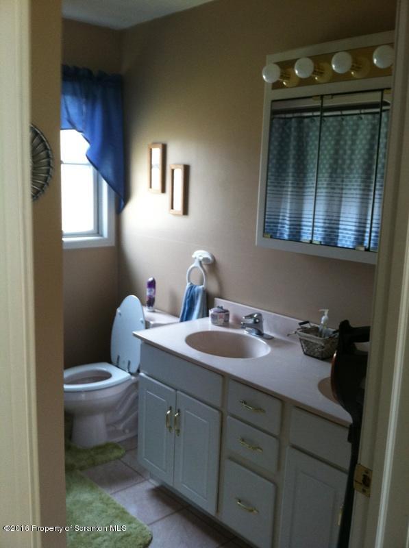 9021 State Rte 6 Meshoppen, PA 18630 - Photo 13 of 16 a bathroom with a toilet sink and mirror