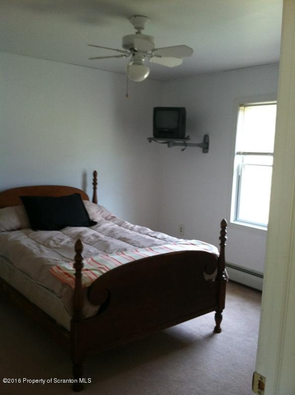 9021 State Rte 6 Meshoppen, PA 18630 - Photo 15 of 16 a bedroom with a bed and a television