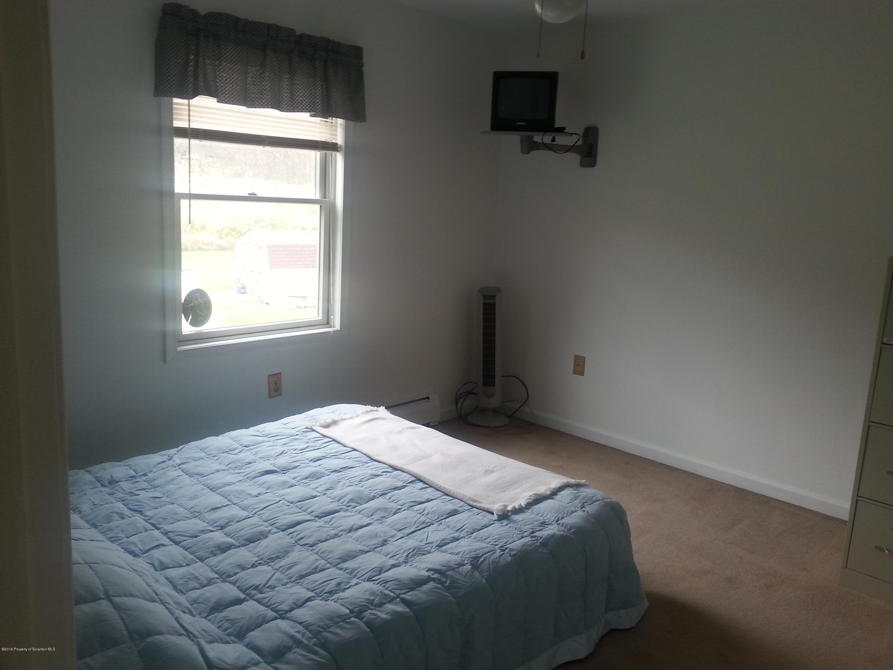 9021 State Rte 6 Meshoppen, PA 18630 - Photo 16 of 16 a bedroom with a bed and a window