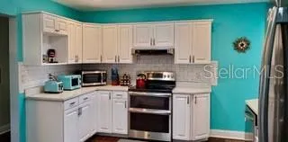 a kitchen with cabinets and appliances