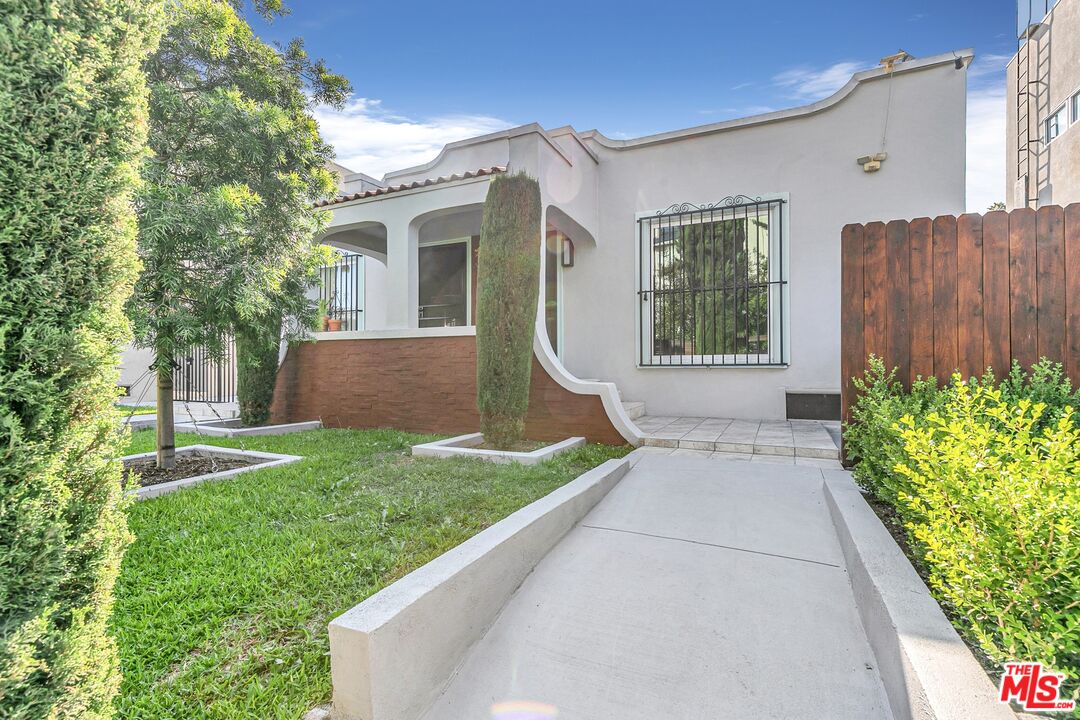 123 North Reno Street Los Angeles, CA 90026 - Photo 1 of 28 a view of backyard with potted plants and a large tree