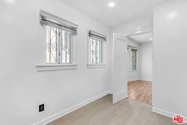 an empty room with windows and closet