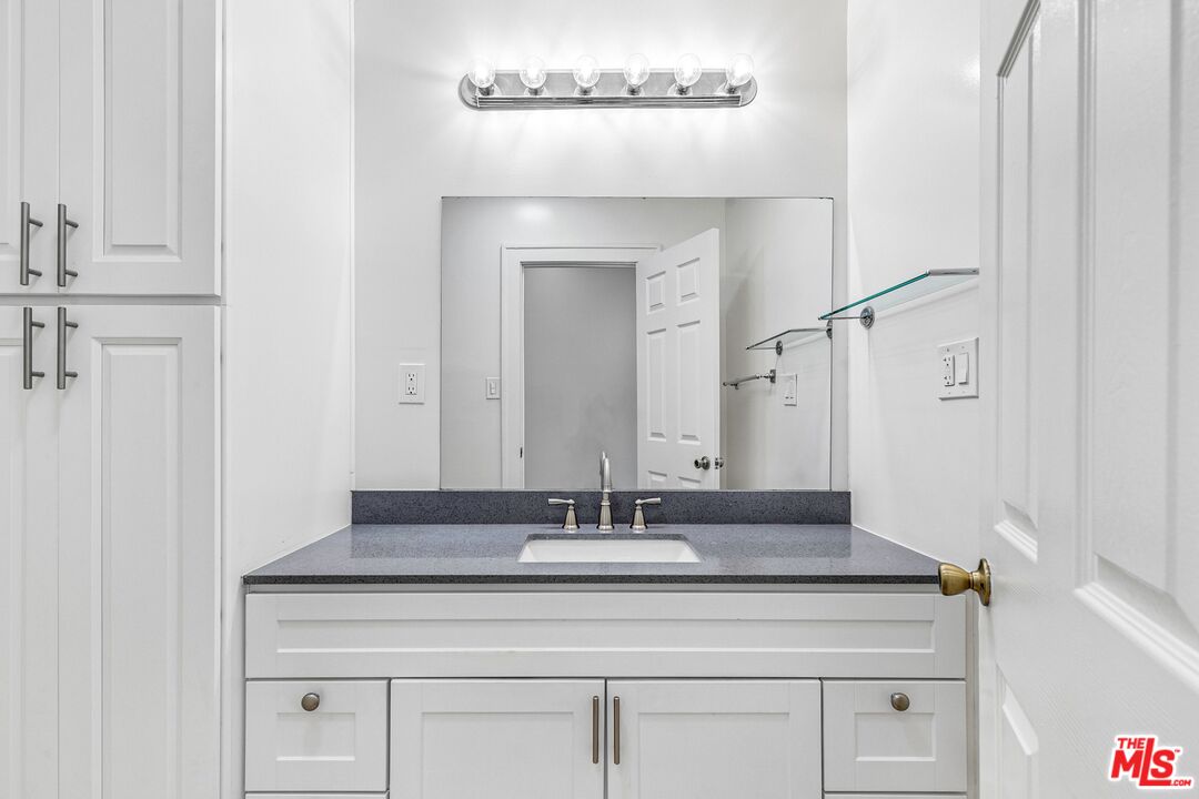123 North Reno Street Los Angeles, CA 90026 - Photo 16 of 28 a bathroom with a sink and a mirror