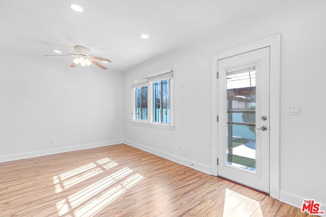 123 North Reno Street Los Angeles, CA 90026 - Photo 21 of 28 a view of an empty room with window and wooden floor