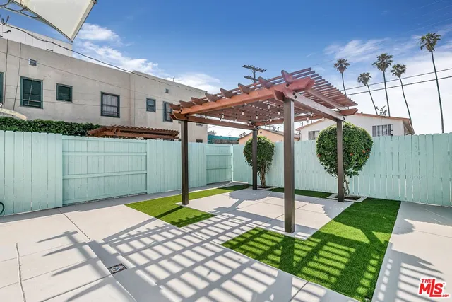 a view of a patio with a table and chairs
