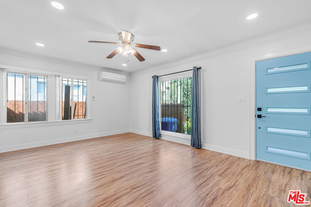 123 North Reno Street Los Angeles, CA 90026 - Photo 4 of 28 a view of an empty room with window and wooden floor