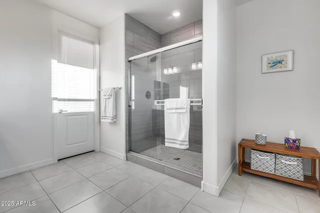 a spacious bedroom with a bed and a chandelier