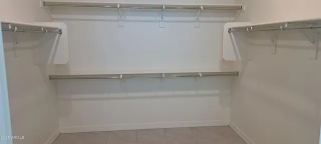 a spacious bathroom with a double vanity sink and a mirror