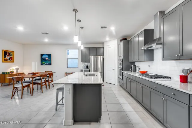 a kitchen with stainless steel appliances granite countertop a sink and refrigerator