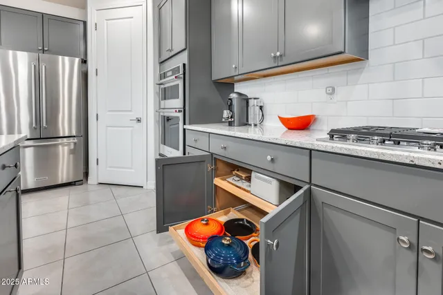a kitchen with stainless steel appliances kitchen island granite countertop a sink and cabinets