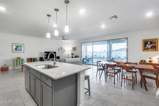 a kitchen with stainless steel appliances granite countertop a refrigerator and a stove