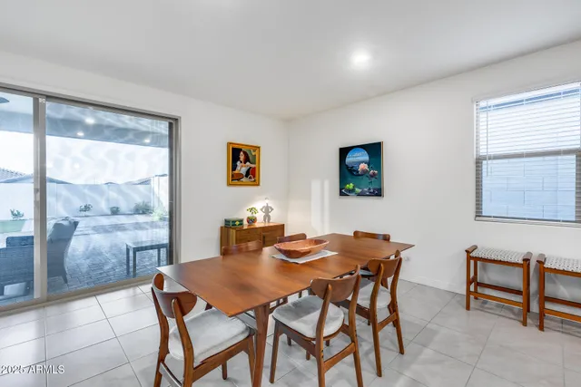 a kitchen with a sink a counter top space and living room view