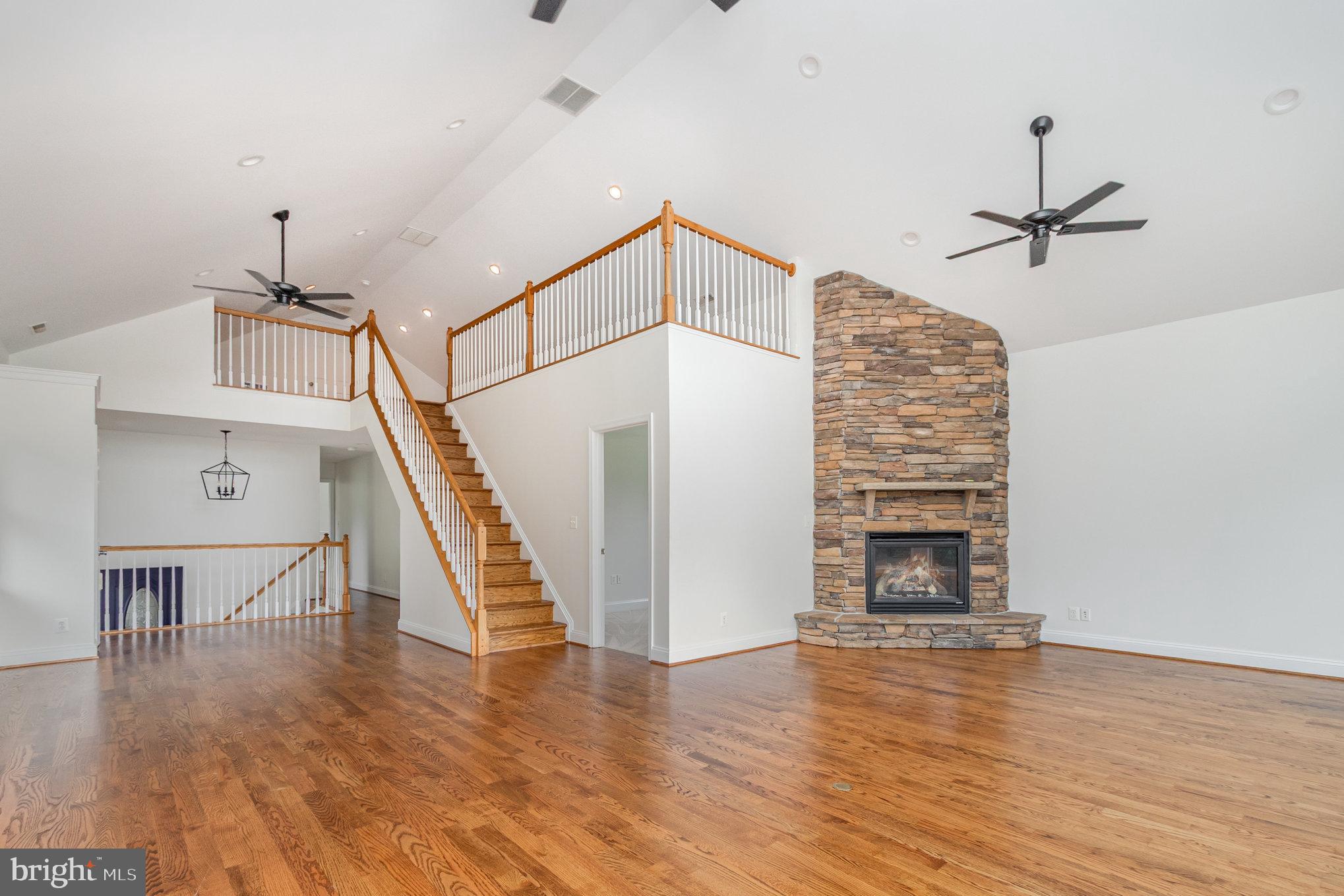 70 Johnson Road Pasadena, MD 21122 - Photo 13 of 35 a view of a livingroom with wooden floor and staircase