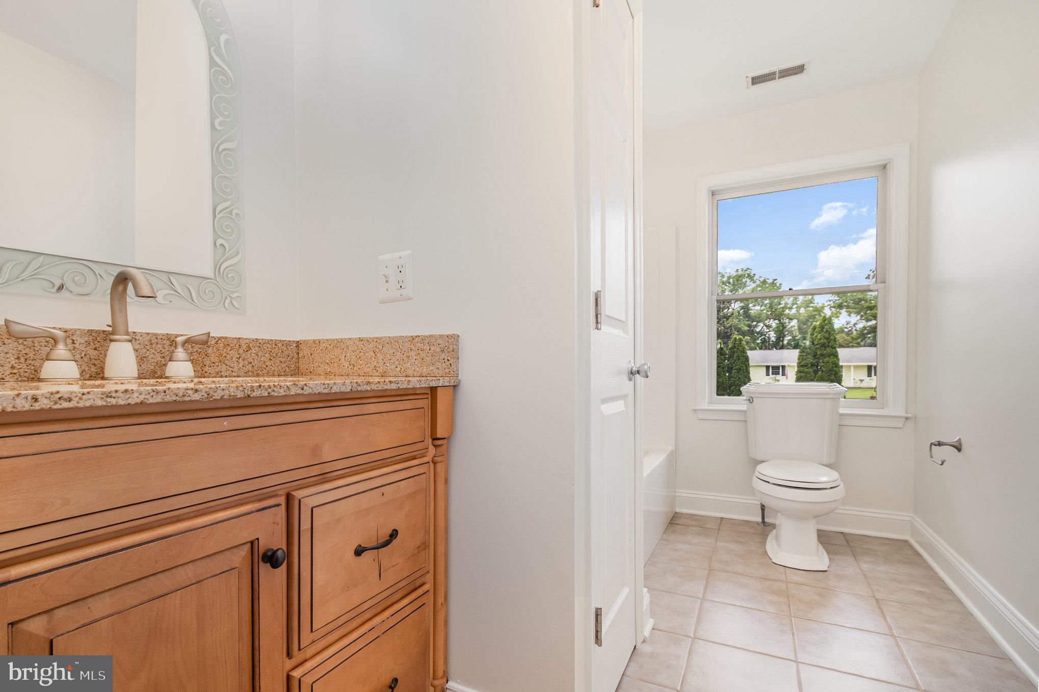 70 Johnson Road Pasadena, MD 21122 - Photo 20 of 35 a bathroom with a granite countertop toilet and a sink