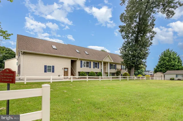 a front view of house with a garden