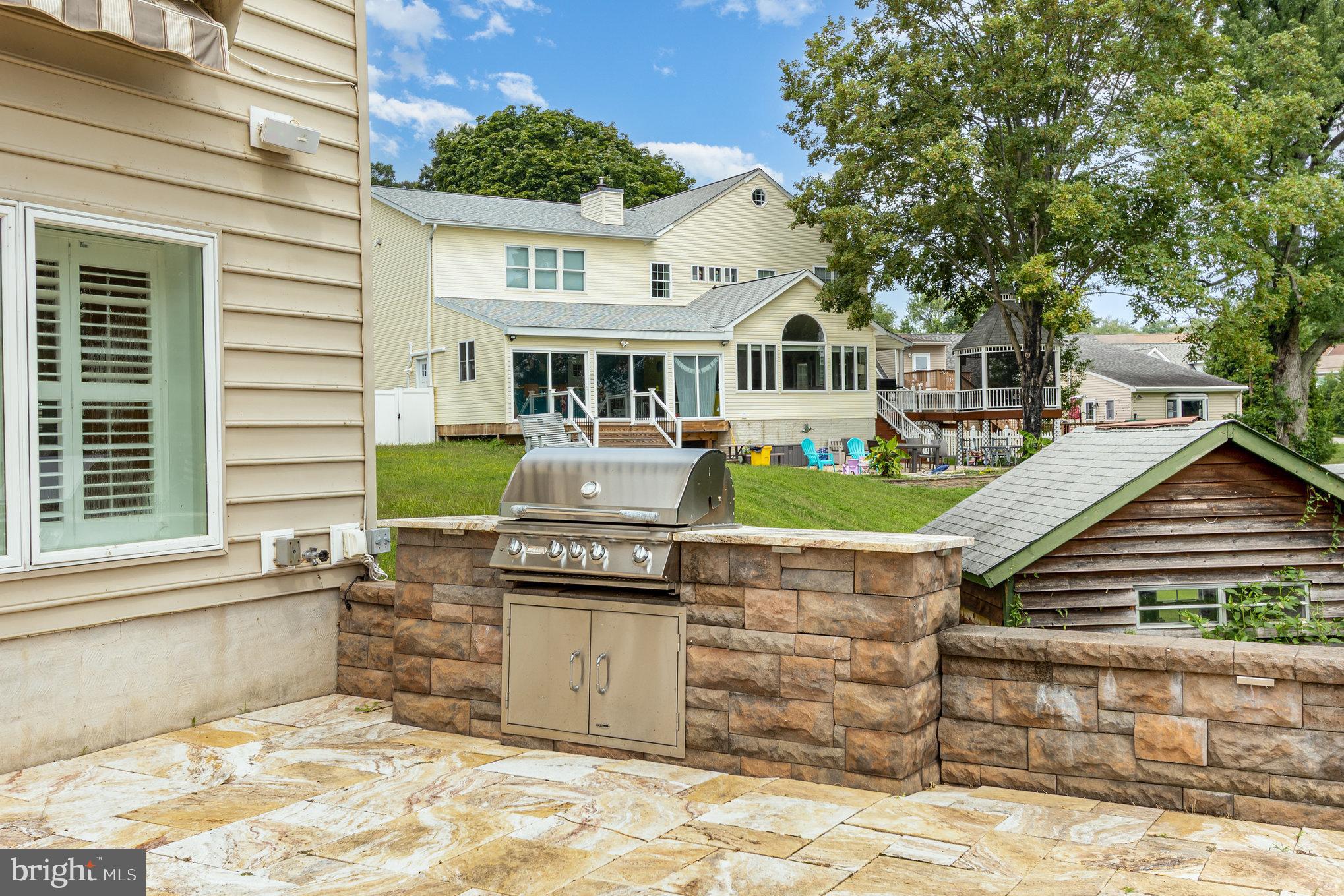 70 Johnson Road Pasadena, MD 21122 - Photo 26 of 35 a front view of a house with a garden and outdoor seating