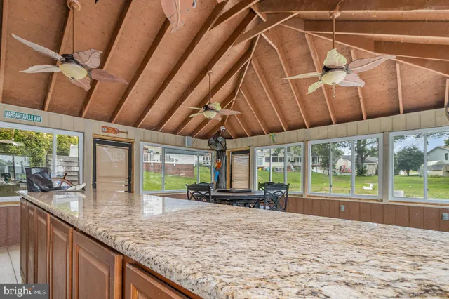 a kitchen with stainless steel appliances wooden cabinets a sink and a large window