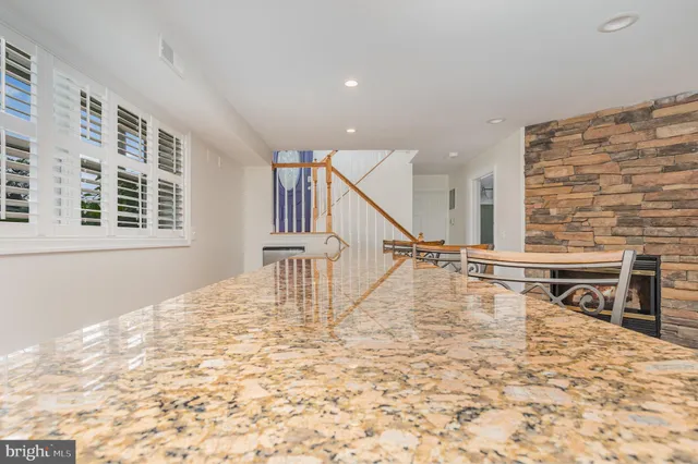 a view of a livingroom with wooden floor and stairs