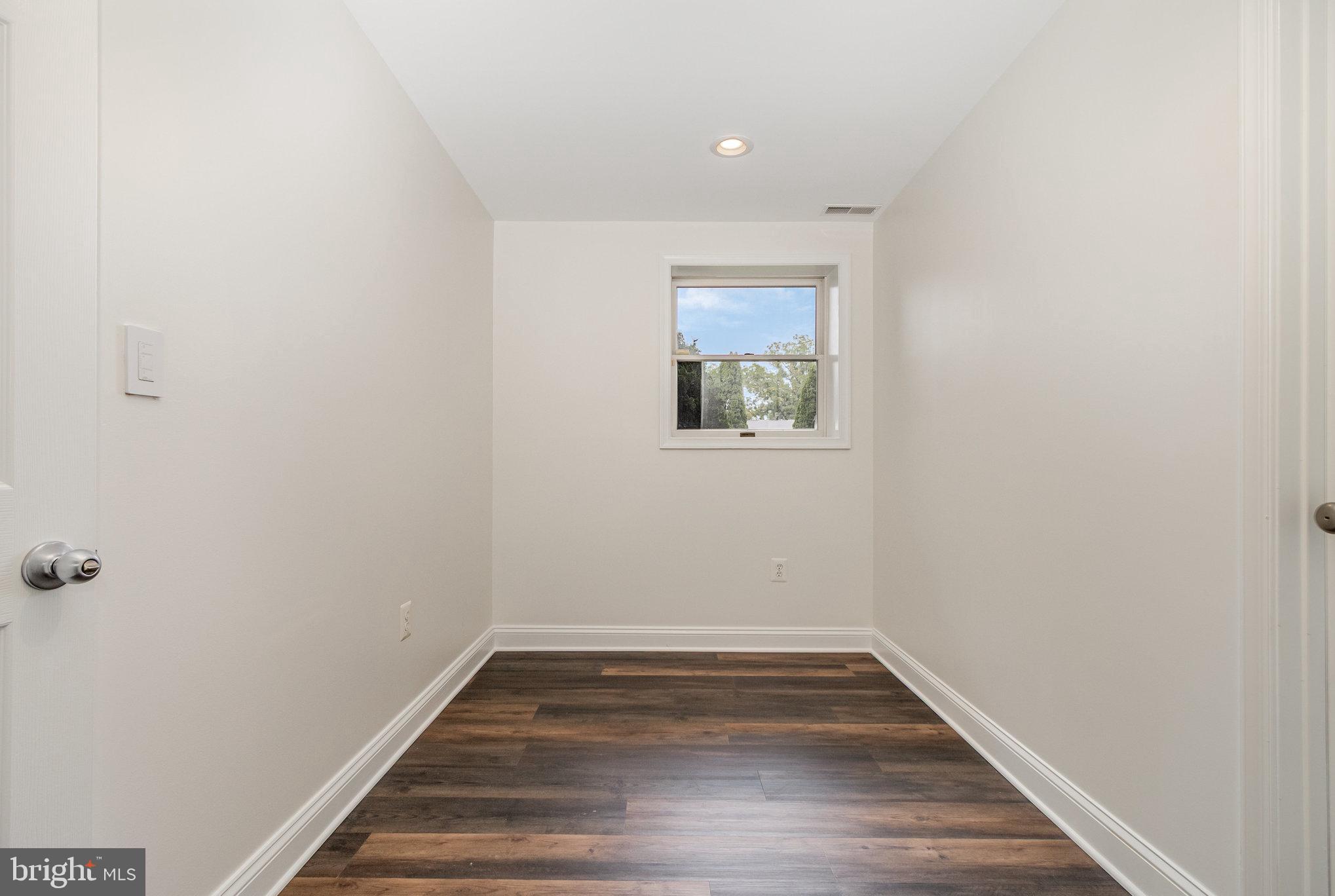 70 Johnson Road Pasadena, MD 21122 - Photo 9 of 35 a view of empty room with wooden floor and fan