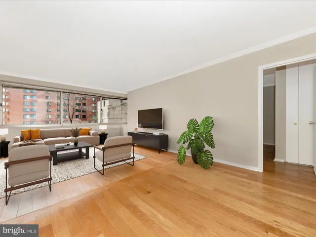 a living room with furniture window and wooden floor